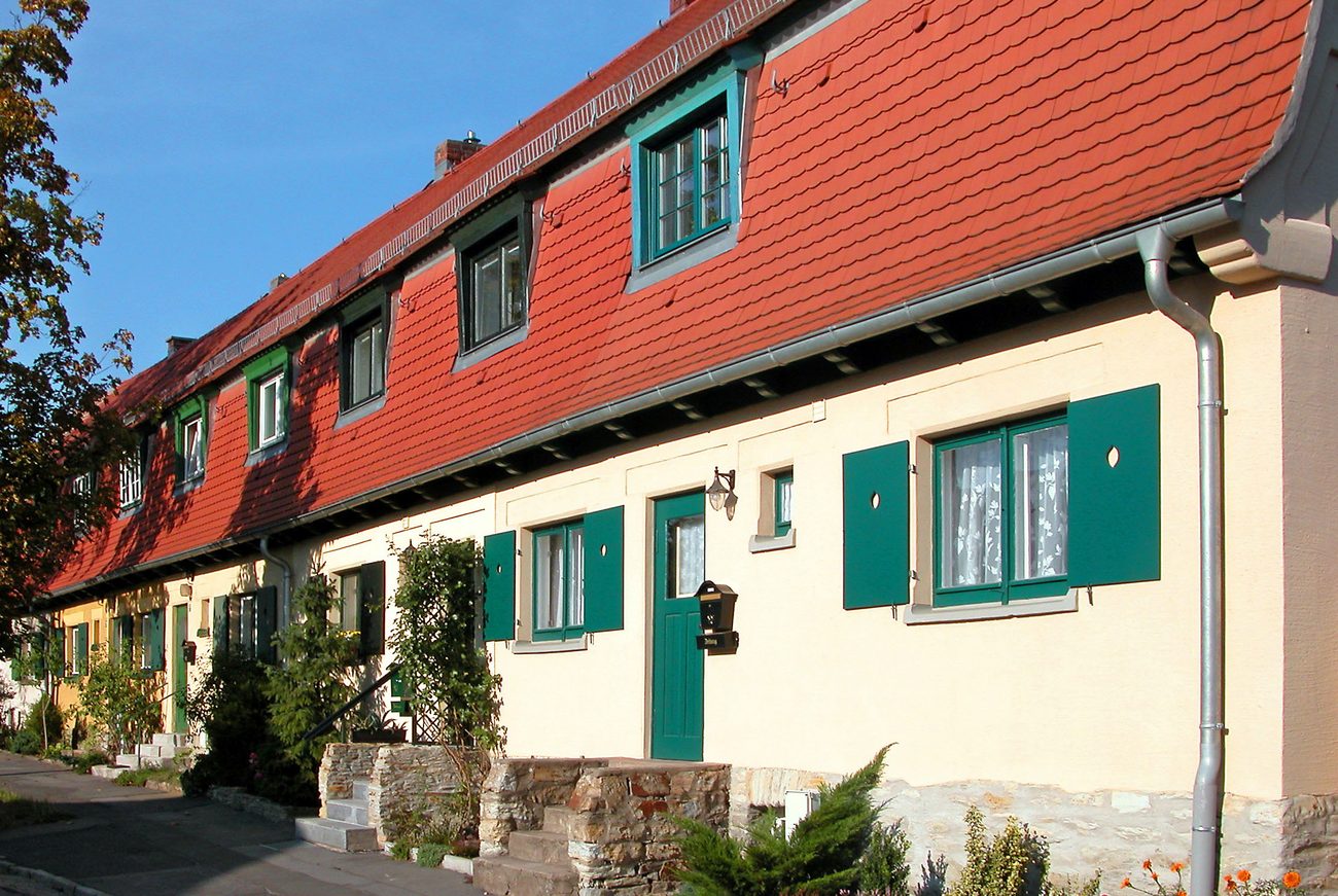 Historische Reihenhaussiedlung, Symbolbild zur Gründungsgeschichte genossenschaftlichen Wohnungsbaus